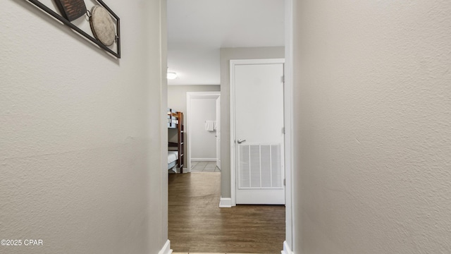 9900 S Thomas Dr Unit 1719, Panama City Beach, FL 32408 - hallway with wood finished floors and a textured wall