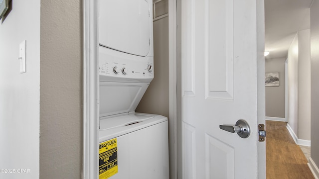 9900 S Thomas Dr Unit 1719, Panama City Beach, FL 32408 - laundry room with stacked washing machine and dryer and wood finished floors
