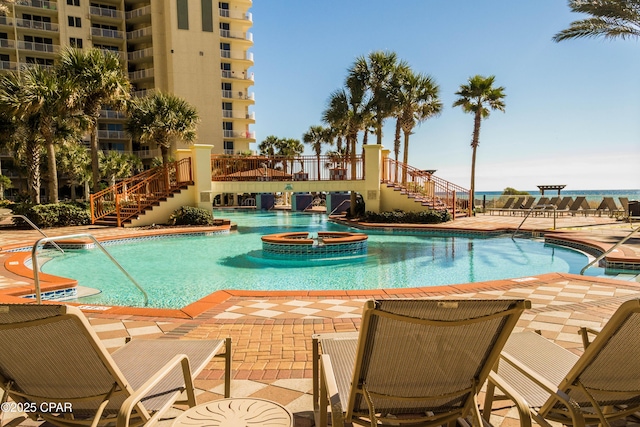 9900 S Thomas Dr Unit 1719, Panama City Beach, FL 32408 - view of swimming pool with stairs, a patio area, and a pool with connected hot tub