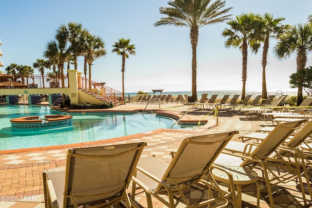 9900 S Thomas Dr Unit 1719, Panama City Beach, FL 32408 - community pool featuring a jacuzzi, a patio area, and stairway