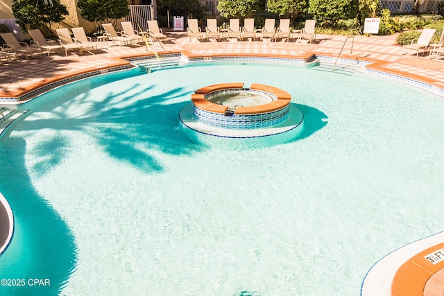 9900 S Thomas Dr Unit 1719, Panama City Beach, FL 32408 - view of pool with a patio and a pool with connected hot tub