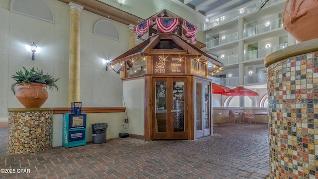 9900 S Thomas Dr Unit 1719, Panama City Beach, FL 32408 - interior space featuring brick floors and a high ceiling