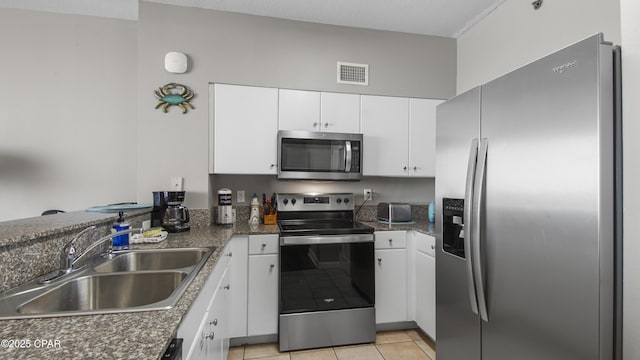 9900 S Thomas Dr Unit 1719, Panama City Beach, FL 32408 - kitchen with appliances with stainless steel finishes, white cabinetry, and dark countertops
