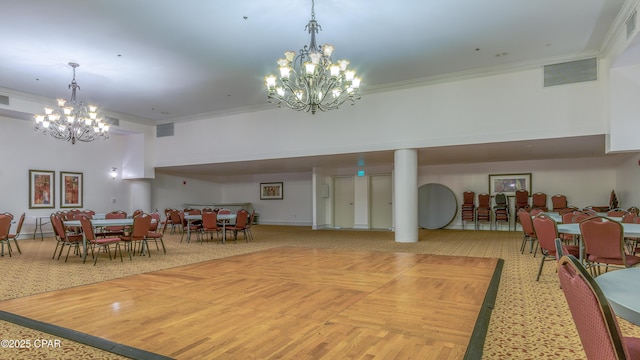 9900 S Thomas Dr Unit 1719, Panama City Beach, FL 32408 - dining room featuring a chandelier, ornamental molding, light carpet, and a high ceiling