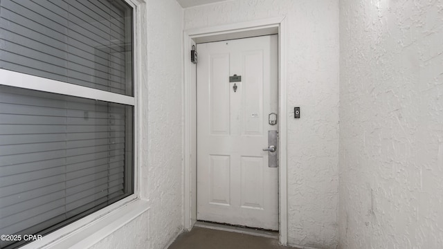 9900 S Thomas Dr Unit 1719, Panama City Beach, FL 32408 - view of exterior entry with stucco siding