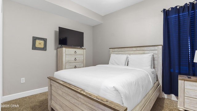 carpeted bedroom featuring baseboards