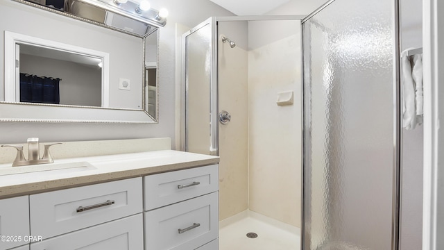 bathroom featuring a shower stall and vanity