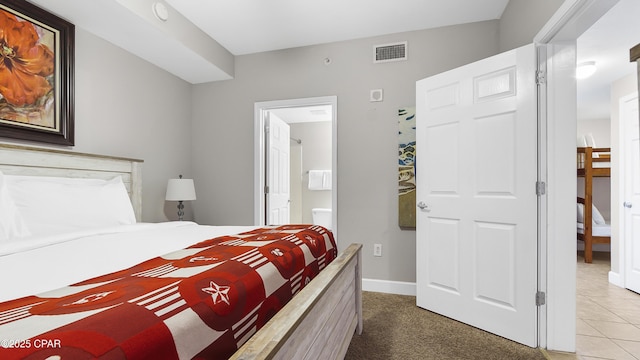 bedroom featuring baseboards and ensuite bathroom