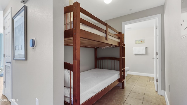 bedroom with tile patterned floors and baseboards
