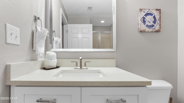 full bath with vanity and an enclosed shower