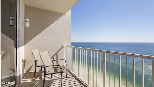 balcony featuring view of water and beach
