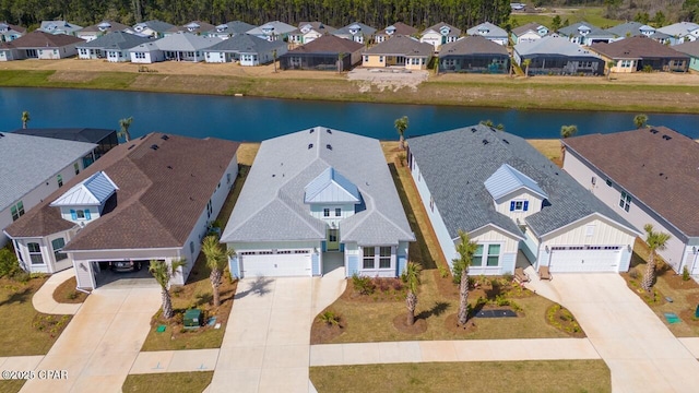 birds eye view of property with a residential view and a water view