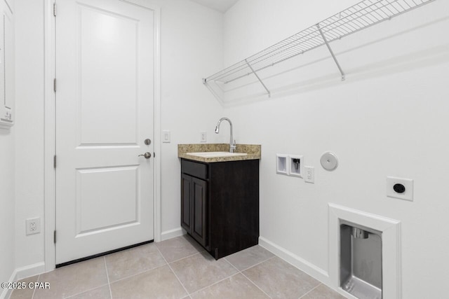 washroom featuring gas dryer hookup, hookup for an electric dryer, a sink, and baseboards