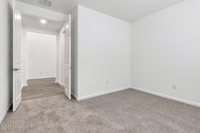 unfurnished room with baseboards, carpet, visible vents, and recessed lighting