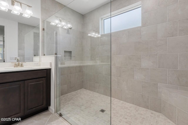 full bathroom with a walk in shower, tile patterned flooring, and vanity