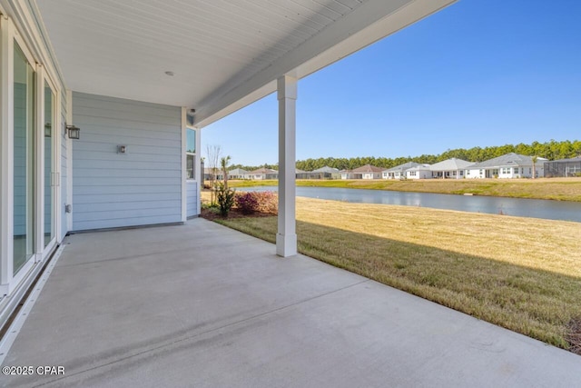 view of patio / terrace featuring a water view and a residential view