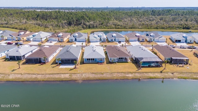 bird's eye view featuring a water view, a residential view, and a forest view