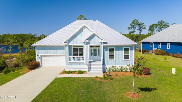 365 Confidence Way, Panama City, FL 32409 - view of front of property featuring board and batten siding, covered porch, a front yard, concrete driveway, and metal roof