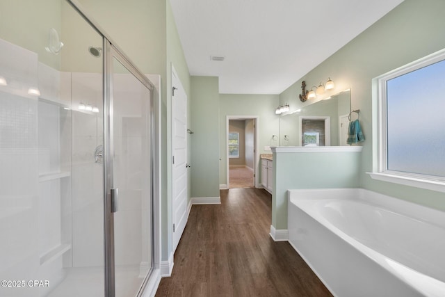 365 Confidence Way, Panama City, FL 32409 - full bathroom featuring wood finished floors, plenty of natural light, a garden tub, and a shower stall