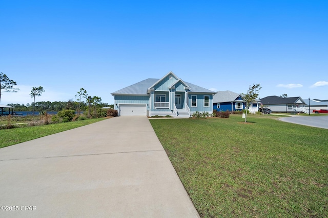 365 Confidence Way, Panama City, FL 32409 - view of front facade featuring board and batten siding, driveway, a front yard, and a garage