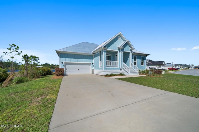 365 Confidence Way, Panama City, FL 32409 - ranch-style home featuring board and batten siding, driveway, a front yard, covered porch, and metal roof