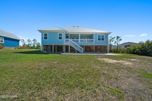 365 Confidence Way, Panama City, FL 32409 - back of house featuring stairs, metal roof, and a yard