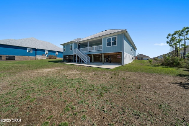 365 Confidence Way, Panama City, FL 32409 - rear view of property with a patio, stairway, metal roof, and a lawn
