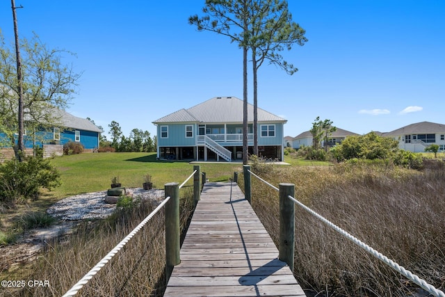 365 Confidence Way, Panama City, FL 32409 - rear view of property with stairway, a yard, and metal roof