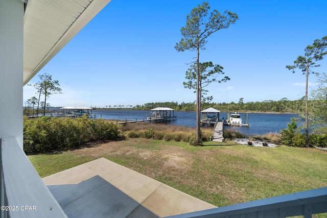 365 Confidence Way, Panama City, FL 32409 - view of grassy yard featuring a boat dock, a water view, and a patio