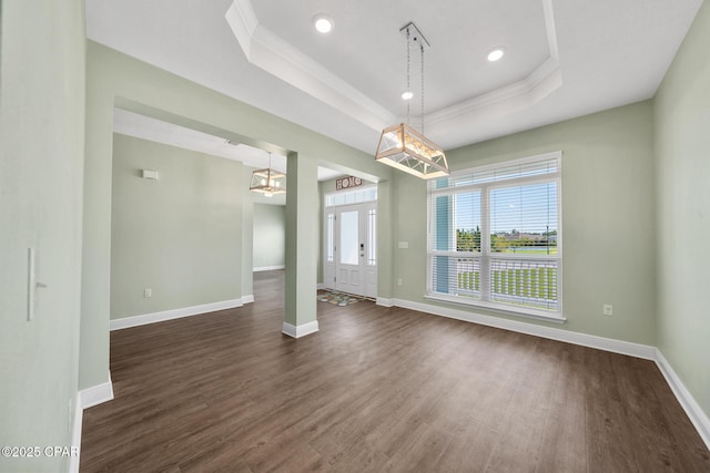 365 Confidence Way, Panama City, FL 32409 - empty room with a chandelier, a tray ceiling, dark wood-style flooring, baseboards, and crown molding