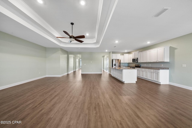 365 Confidence Way, Panama City, FL 32409 - kitchen featuring a raised ceiling, appliances with stainless steel finishes, open floor plan, crown molding, and recessed lighting