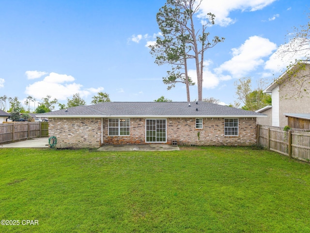 rear view of house featuring a fenced backyard, a yard, and a patio area