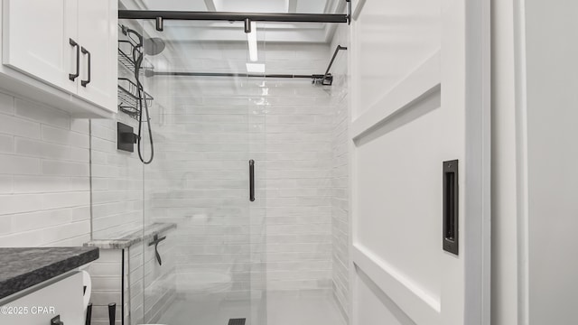full bathroom featuring vanity and a shower stall
