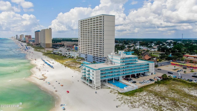 birds eye view of property featuring a city view, a view of the beach, and a water view
