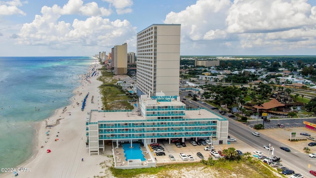 drone / aerial view featuring a beach view and a water view