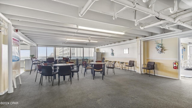 dining space with carpet floors, baseboards, and a wealth of natural light