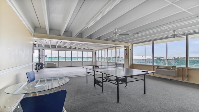 recreation room featuring a wall mounted air conditioner, ceiling fan, and carpet flooring