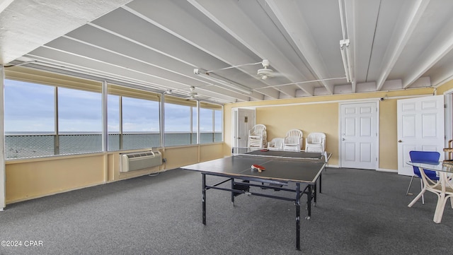 game room featuring carpet flooring and a wall unit AC