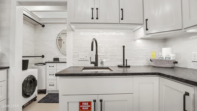 laundry area featuring washer / dryer, laundry area, and a sink