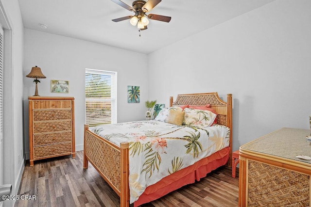 bedroom featuring ceiling fan, baseboards, and wood finished floors