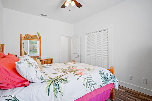 bedroom with a closet, baseboards, visible vents, ceiling fan, and wood finished floors