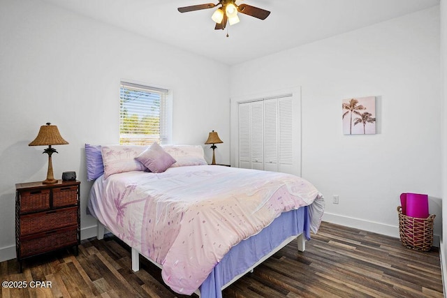 bedroom with a closet, baseboards, a ceiling fan, and dark wood-style floors