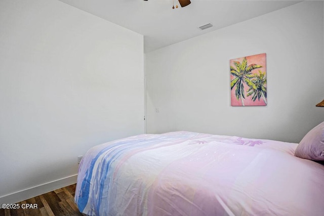 bedroom with visible vents, baseboards, a ceiling fan, and wood finished floors