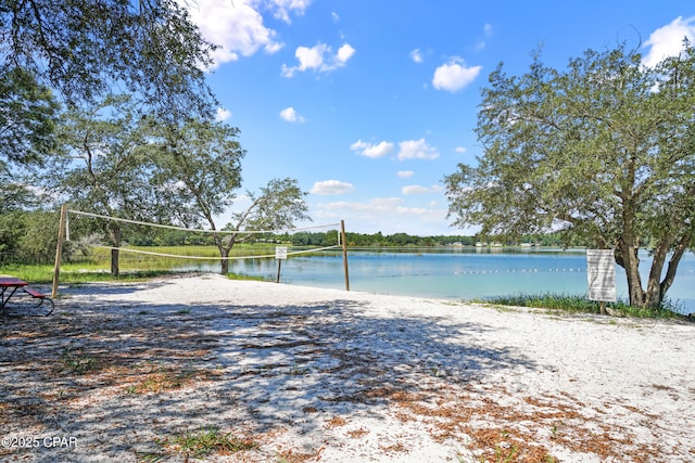 view of home's community featuring a water view and volleyball court