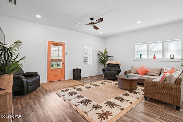 living room featuring visible vents, baseboards, a ceiling fan, recessed lighting, and wood finished floors