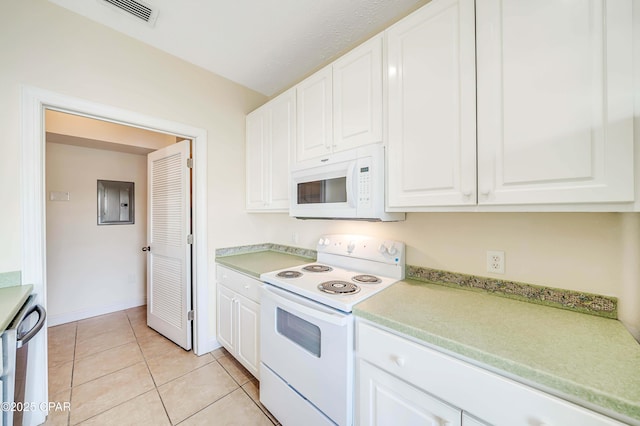 kitchen featuring visible vents, light countertops, white appliances, and white cabinetry
