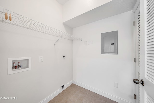 clothes washing area with electric panel, baseboards, electric dryer hookup, laundry area, and light tile patterned floors