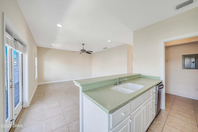 kitchen featuring a sink, light tile patterned flooring, visible vents, dishwasher, and light countertops