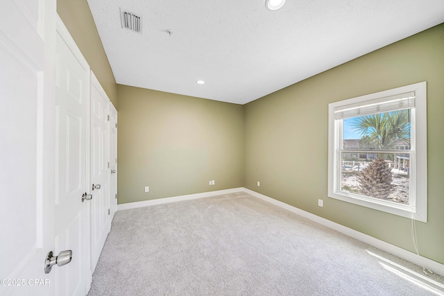 unfurnished bedroom with recessed lighting, baseboards, visible vents, and light colored carpet