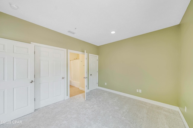 unfurnished bedroom featuring connected bathroom, light carpet, baseboards, visible vents, and recessed lighting